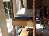 a wooden table with a potted plant on top of it
