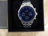 a close up of a watch in a box on a table