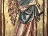 an image of a statue of an angel holding a trumpet