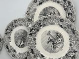 several black and white plates with a picture of a man and a woman on them