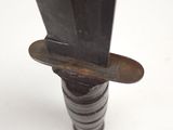a close up of a knife with a blade stuck in it