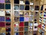 a room filled with lots of different colored balls of yarn