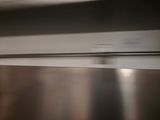 a blurry photo of a kitchen counter with a microwave
