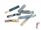 many different types of knives on a white surface