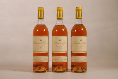 three bottles of wine sitting next to each other on a white surface