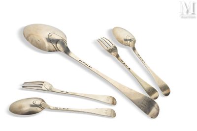a silver spoon, fork, and spoon rest on a white surface