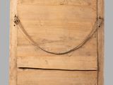 an old wooden door with a rope hanging from it ' s side