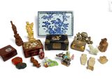 a small assortment of asian figurines in a box