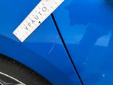 a sticker on the side of a blue car that says v p pluto