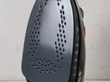 a black and silver iron sitting on a white table