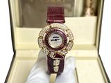 someone is holding a watch in a box with diamonds on it