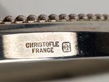 a close up of a silver plate with a name on it
