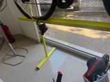 a bike that is sitting on a stand in front of a window