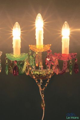 a chandelier that has five candles on it