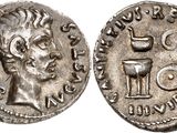 a silver coin with an image of a man holding a wine glass