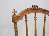 a wooden chair that has a wooden seat and a wooden arm rest