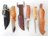 several different types of knives are lined up on a white surface