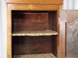 a wooden cabinet with a door open on a white background