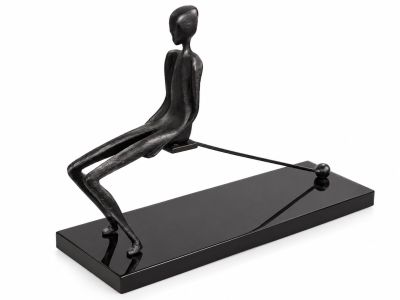 the statue of a man is sitting on a black base