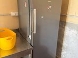 a refrigerator and a bowl on a table in a kitchen