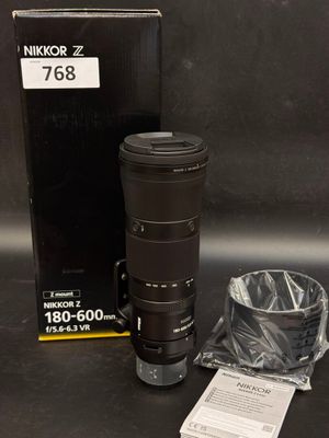 a camera lens sitting on a table next to a box