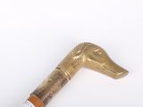 a gold colored cane with a bird head on it