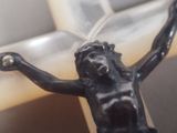 a small statue of jesus on a cross on a table