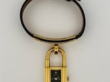 an image of a gold plated watch with a padlock on it
