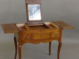 a small wooden table with a mirror on top of it