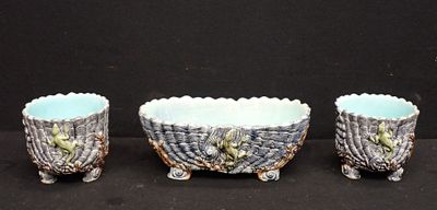 three small bowls are lined up on a black surface