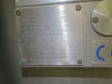 a close up of a metal sign on a wall