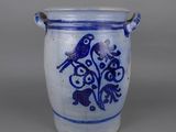 blue and white vase with two birds on it sitting on a table