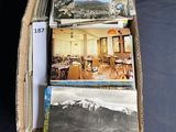 a cardboard box full of postcards with pictures in it