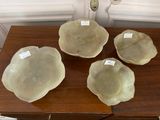 four bowls on a table with labels on them sitting on top of a wooden table