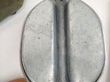 a metal toilet with a wooden seat next to it