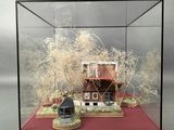 a small model of a house in a glass case