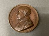 a bronze coin with a picture of a man on it
