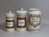 three jars that are sitting next to each other on a table