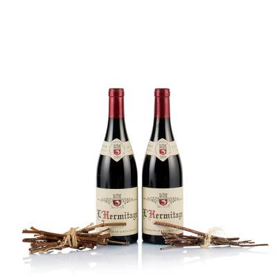 a couple of bottles of wine sitting on top of a table