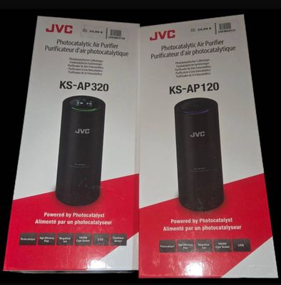 two boxes of jvc products sit on a black surface