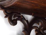a close up of a wooden shelf with a clock on it