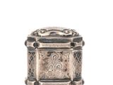 an antique silver box with a decorative design on the lid