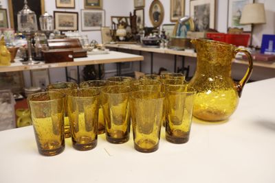 a lot of glasses and a pitcher on the table