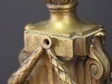 an antique brass figurine of a man with a hat and a cane