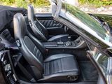 an image of a black convertible car with its doors open