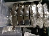 a lot of silver spoons and spoons in a box