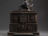 an antique wooden chest with a bird on top of it