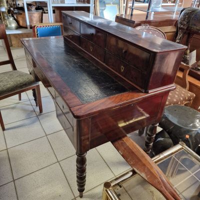 a desk with a drawer on top of it in a room