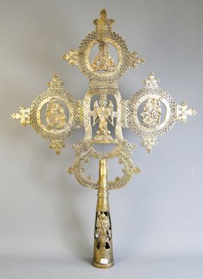 a gold cross that is sitting on a table