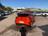 the rear end of a red car parked in a parking lot